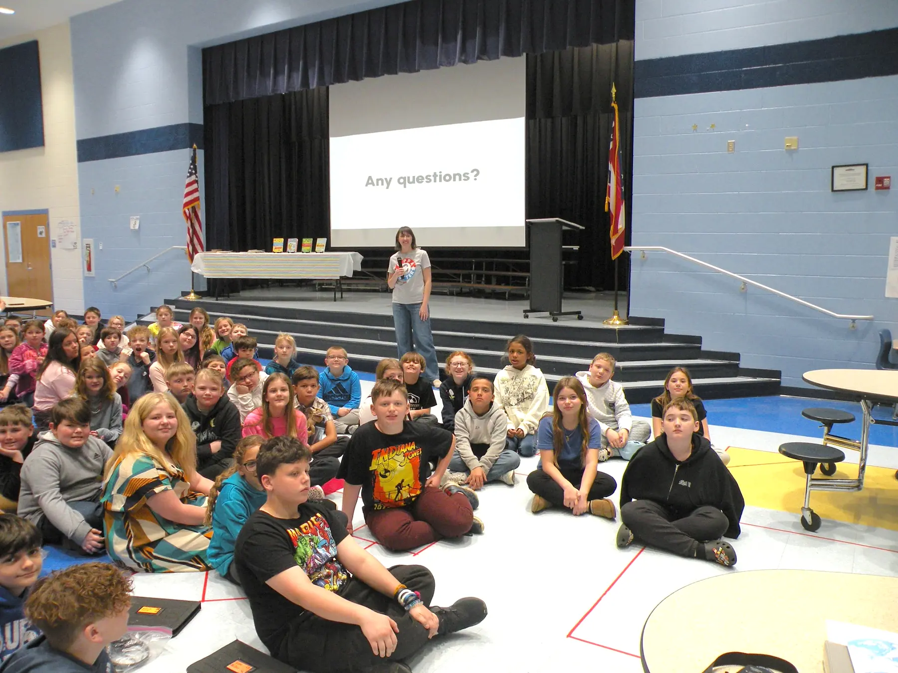 Elizabeth James with a large group of elementary students after an author presentation